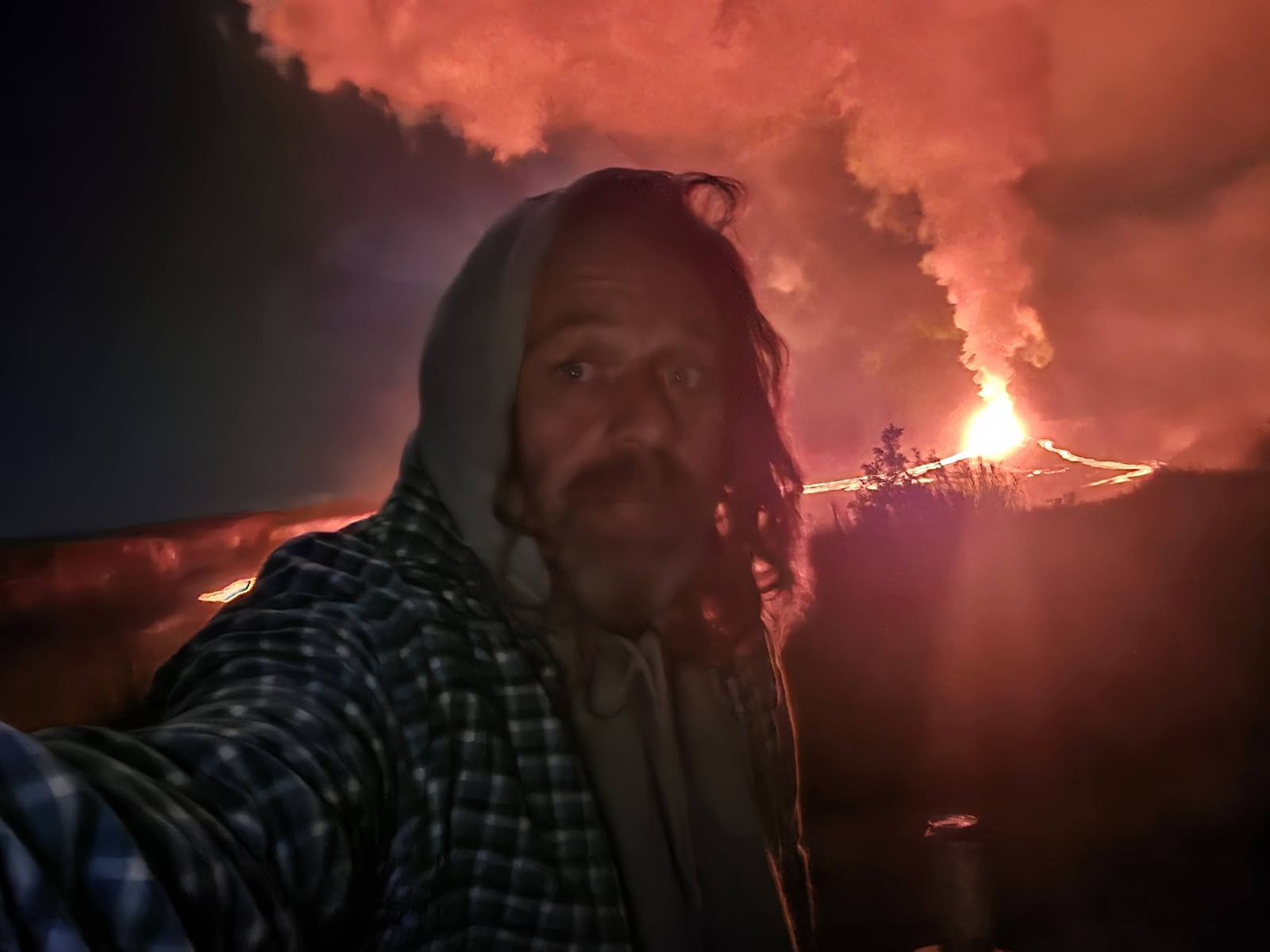 Jessie in a hoodie with the eruption glow behind