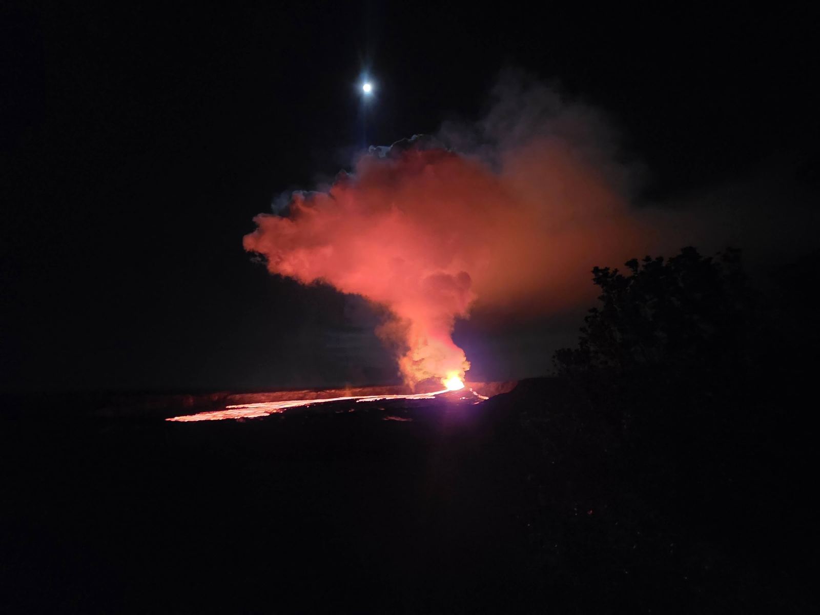 Glowing eruption plume against the night sky